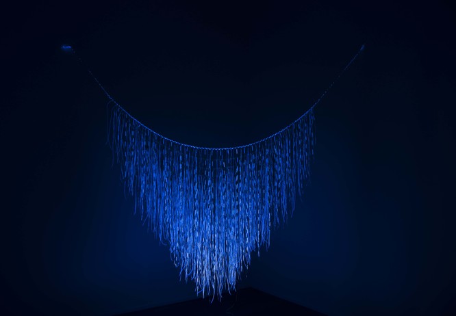 Maureen Lander Wai o te Marama 2004, Harakeke, muka, nylon line, fluorescent paint, UV lighting. Collection of Christchurch Art Gallery Te Puna o Waiwhetū, purchased 2021. Photo: Ellie Smith